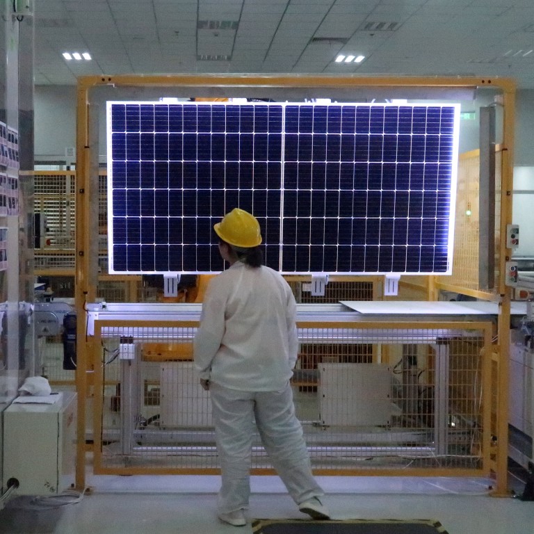 A worker checks a solar module at Longi Green Technology in Xian, Shaanxi province, China. Photo: Reuters