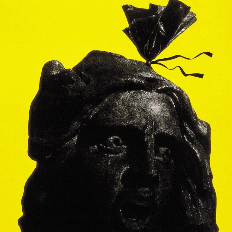 “The Earth: Triumph in Paris” (1997) by Henry Steiner shows a disembodied head inside a garbage bag, drawing attention to the pollution and waste created on our planet. CREDIT: Hong Kong Design Centre