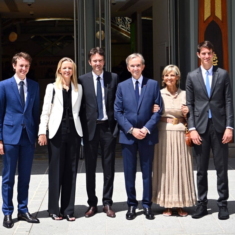 Head of French multinational corporation LVMH Bernard Arnault (centre) and his wife Hélène (second from right), surrounded by their children Frédéric, Delphine, Antoine and Alexandre during a ceremony marking Paris’ iconic department store La Samaritaine reopening after 16 years of closure in Paris, in June 2021. Photo: AFP
