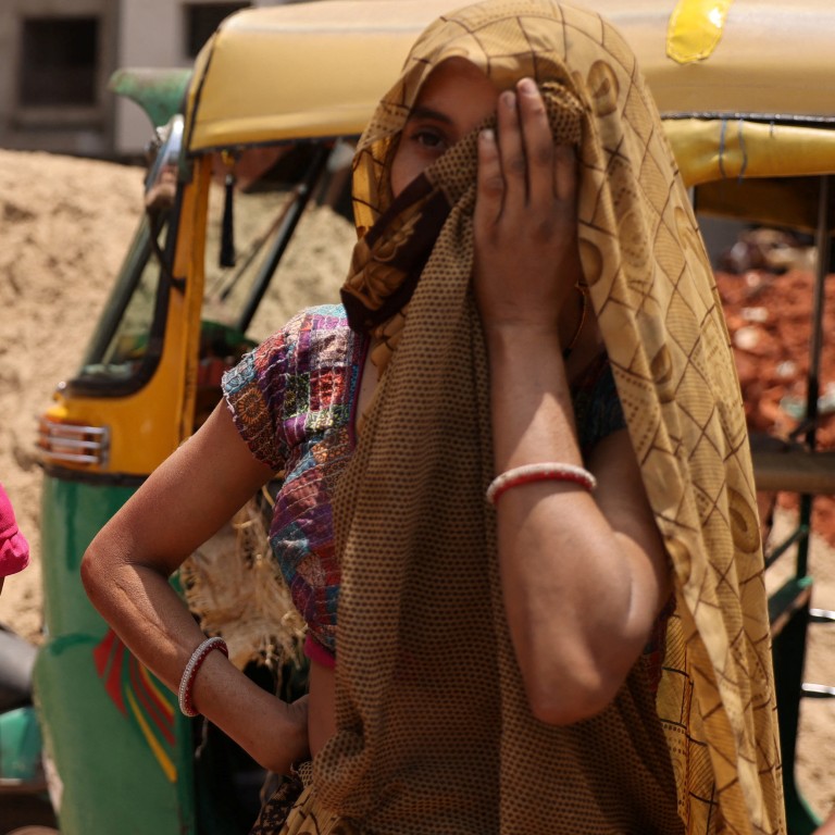 Women take shelter from the sun at a construction site in Ahmedabad, India, on April 28. Photo: Reuters