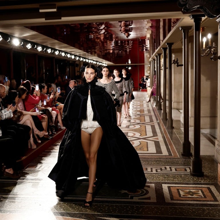 Model Vittoria Ceretti opened the Chanel autumn/winter 2024-25 haute couture show in a voluminous black cape paired with a white bodysuit. Photo: Reuters
