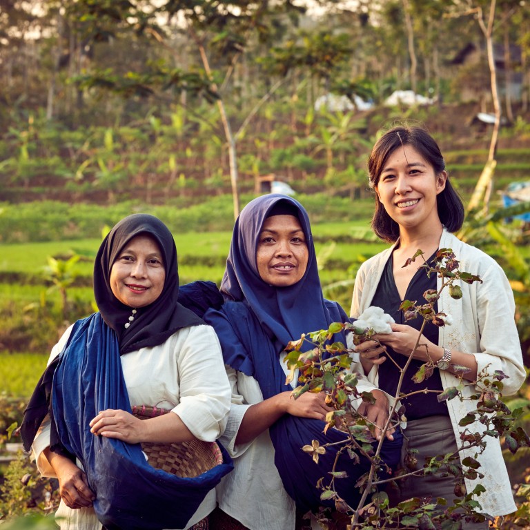 Rolex Awards for Enterprise laureate of 2023 and founder of SukkhaCitta, Denica Riadini-Flesch, holding cotton harvested on a farm near Central Java, Indonesia, by Ibu Tun and Ibu Dair, also pictured. The cotton will be used to make high-quality, traditionally crafted clothes, making SukkhaCitta a true farm-to-closet company. Photos: Handout