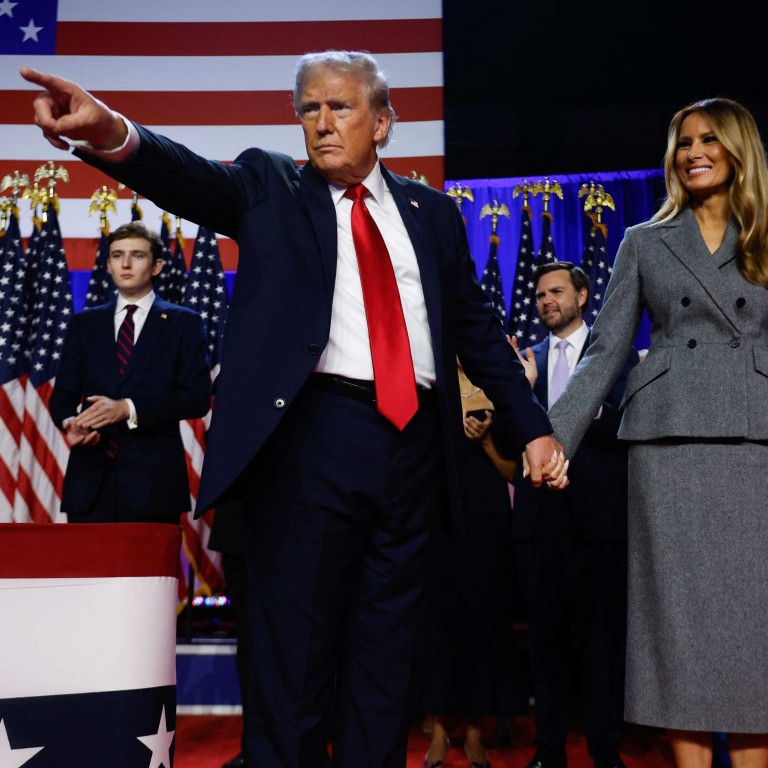 US president-elect Donald Trump points to supporters alongside his wife Melania during an election night event in West Palm Beach, Florida. Photo: Getty