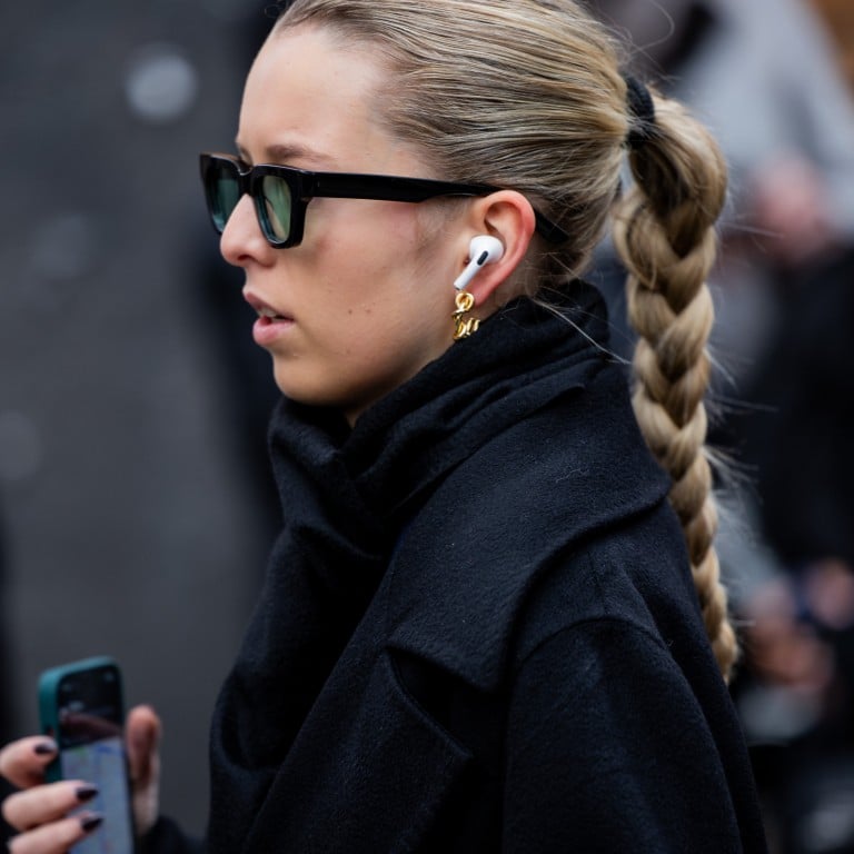 A guest wearing sunglasses and Apple earpods during the Menswear fall/winter 2024-25 as part of Paris Fashion Week. Photo: Getty Images