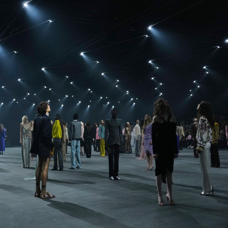 Models looking up at an imaginary sky filled with fireflies at the Valentino spring/summer 2026 show. Photo: AP