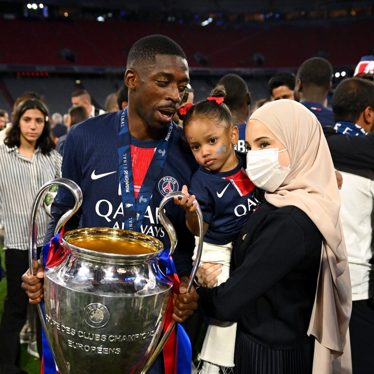 Ousmane Dembélé with his wife, Rima Edbouche, and daughter after his team Paris Saint-Germain’s victory at the UEFA Champions League Final last May. Photo: Getty Images