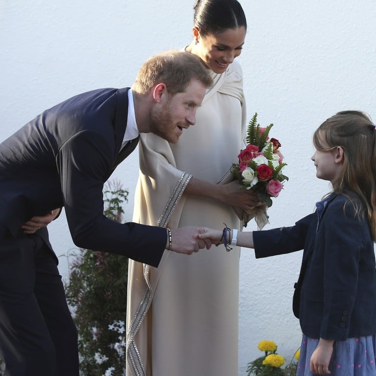 Britain's Prince Harry, Duke of Sussex (left), and his wife, Meghan, Duchess of Sussex – here greeted by Elsa Reilly, 8, and Orla Reilly, 12, the daughters of the British ambassador to Morocco at a reception in February – are expecting the birth of their first child. Photo: AP
