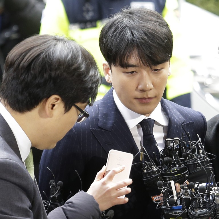 Seungri, centre, member of popular K-pop boy band Big Bang, arrives at the Seoul Metropolitan Police Agency in Seoul on March 14. Photo: Ahn Young-joon / AP Photo
