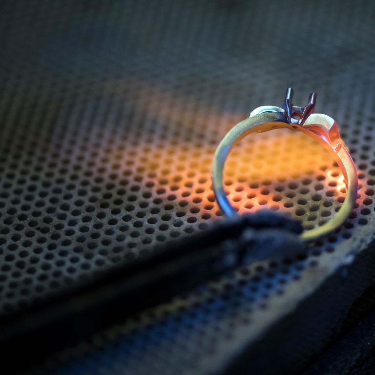 A jeweller works on a ring in an ethical gold jewellery workshop in Paris. Combining attractive and sustainable is the credo of a growing number of jewellers. Photo: AFP