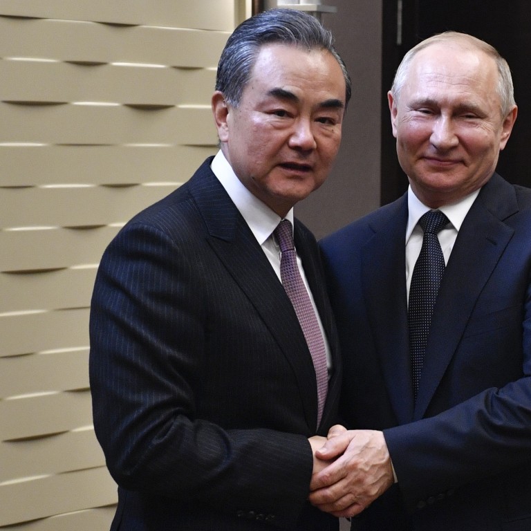 Chinese Foreign Minister Wang Yi with Russian President Vladimir Putin in Sochi on Monday. Photo: AP
