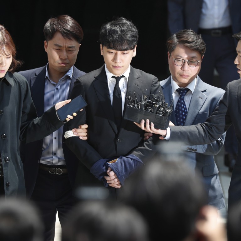 South Korean singer-songwriter Seungri (centre) – a former member of the K-pop boy band, Big Bang – speaks to the media, while awaiting the court's decision about his arrest warrant hearing, outside Seoul District Court in Seoul, South Korea, on Tuesday. Photo: EPA-EFE