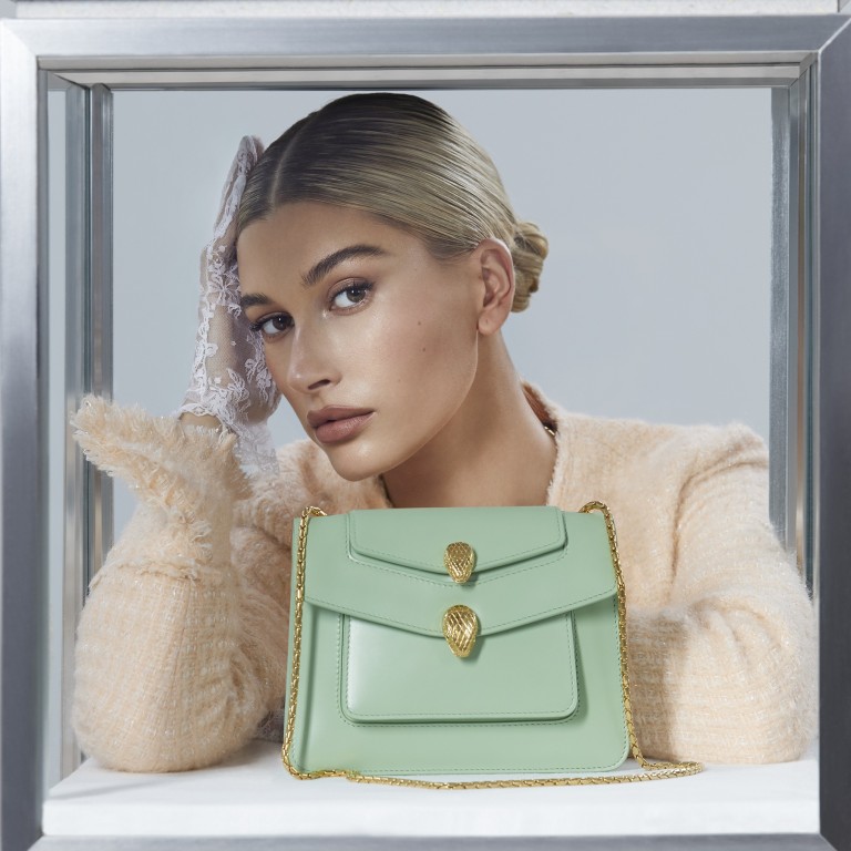 Hailey Bieber shows off one of the bags from the collection, which reinterprets the iconic Serpenti Forever Bag with Wang’s signature high-low style.