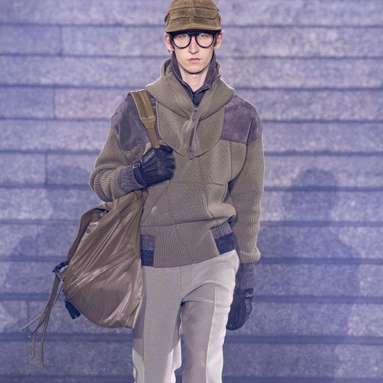 A model presents creations, including a voluminous holdall, from Ermenegildo Zegna’s fall/winter 2019 collection, which features designs made from fabrics that have been recycled from pre-existing sources and also made to be recyclable.