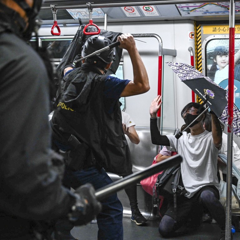 Members of the Special Tactical Squad enter a stationary train at Prince Edward station. Photo: Handout