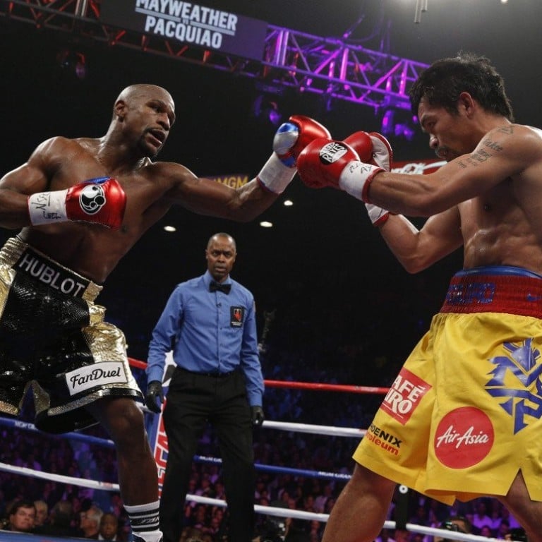 American boxer Floyd Mayweather (left) defeated Manny Pacquiao of the Philippines in the ring when they fought in a welterweight unification championship bout in Las Vegas, in the United States, in May 2015. Photo: AFP