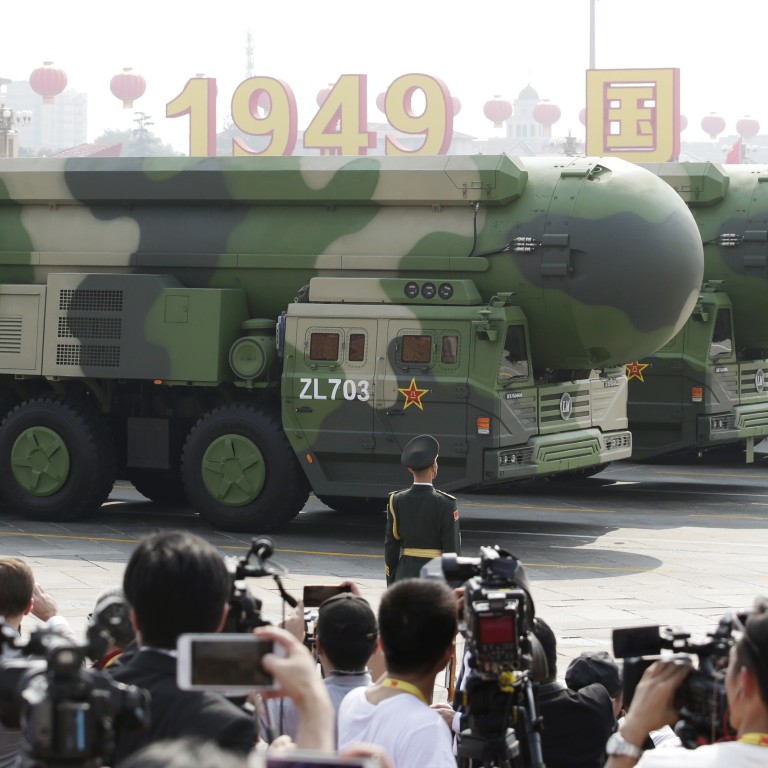 Military vehicles carrying DF-41 intercontinental ballistic missiles travel past Tiananmen Square during the parade on Tuesday. Photo: Reuters