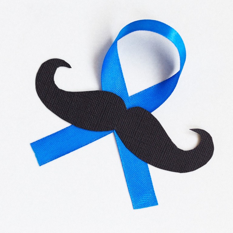 Moustache pattern with blue ribbon symbol is a Movember concept. The Movember movement is to bring awareness to prostate cancer and men’s health in general, including mental health.