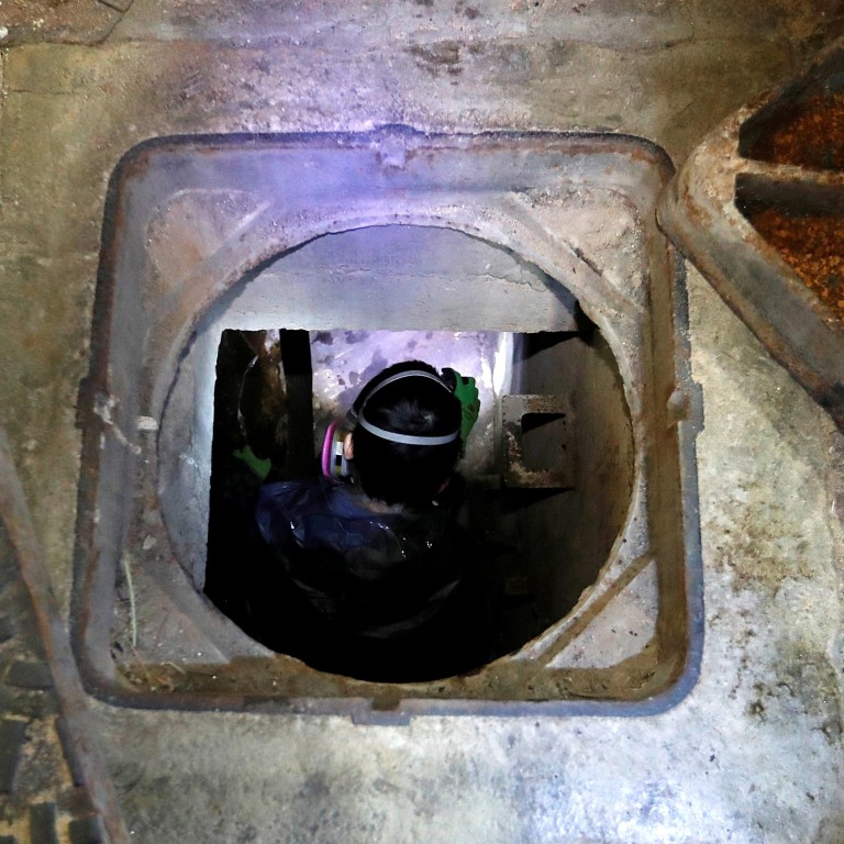 A protester tries to escape through a sewage tunnel inside Polytechnic University. Photo: Reuters