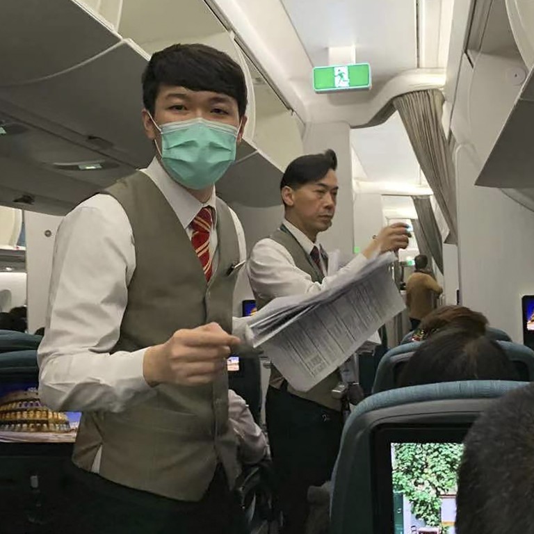 Flight attendants pass out health forms to passengers on a Cathay Pacific flight from Hong Kong to Rome on January 31. Photo: AP