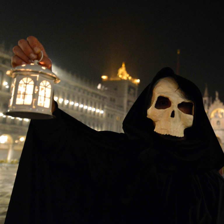 Image result for A masked reveller takes part in the ‘Plague Procession’ on Saint Mark Square in Venice, during the usual period of the Carnival festivities which have been cancelled following an outbreak of the Covid-19 novel coronavirus in northern Italy. Photo: AFP