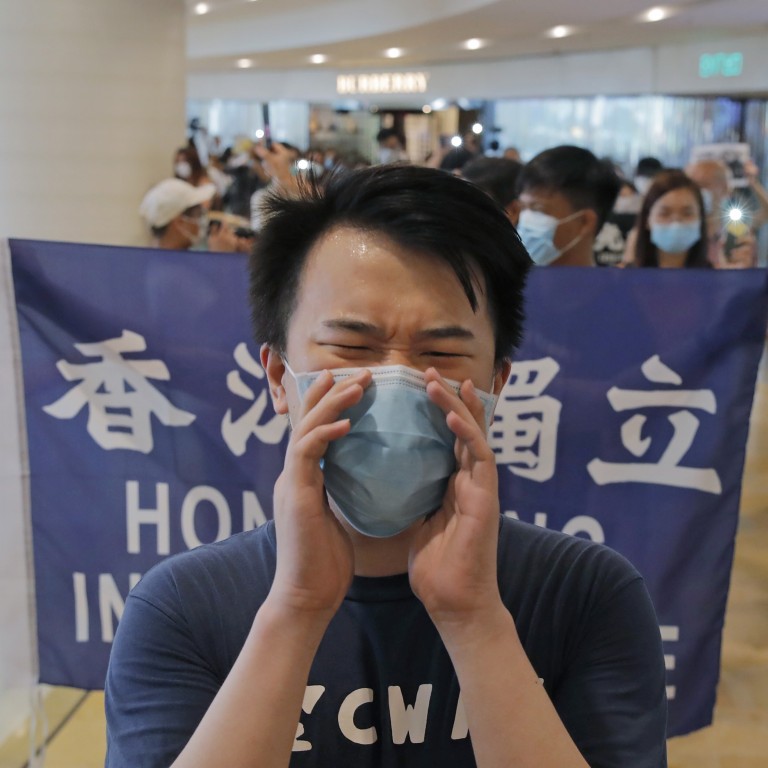 Protesters shout slogans and hold flags in a shopping centre during a protest in Hong Kong earlier this month. Photo: AP