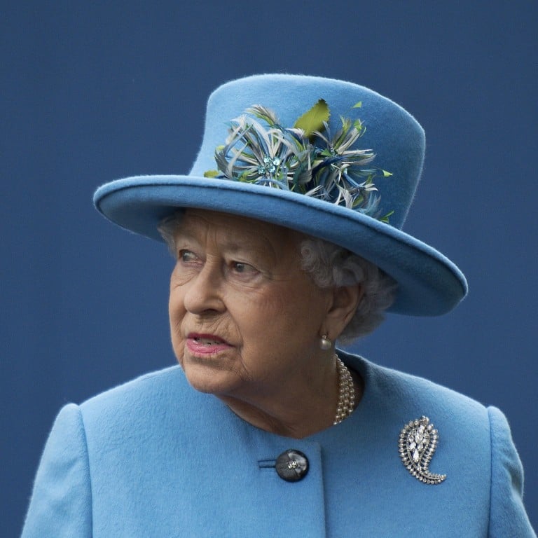 Queen Elizabeth wearing a Cartier palm motif diamond brooch. Photo: AFP