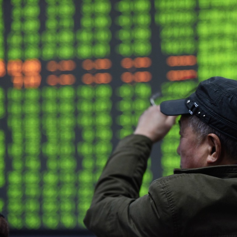 Hong Kong stocks had a nasty fall, but mainland shares fell even more. Here, a stock investor looks at stocks screen in Hangzhou, Zhejiany province, China on February 3, 2020. In China, green signals losses, while red means gains. Photo: EPA-EFE/CHINA OUT