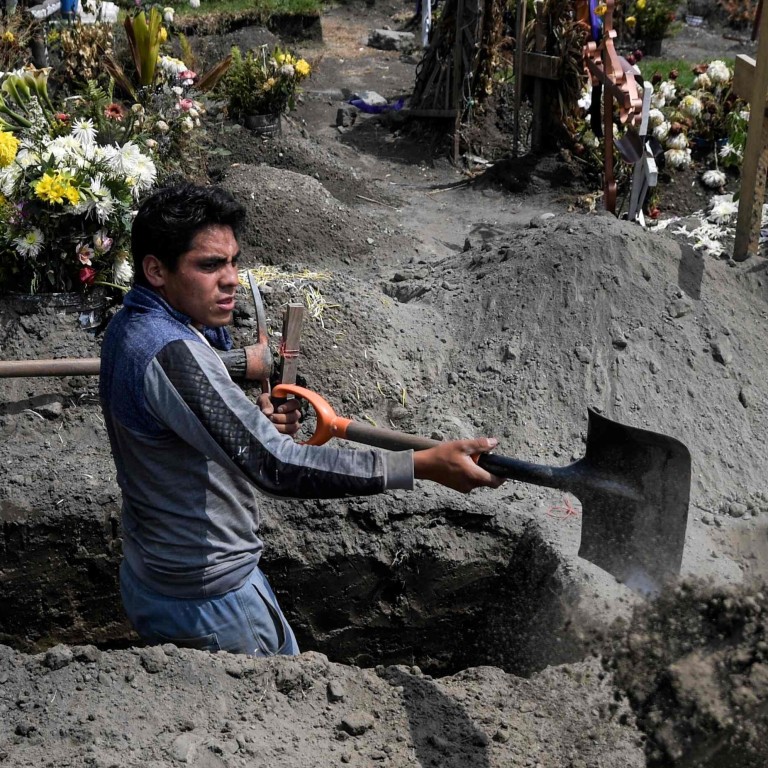 A gravedigger works at the San Miguel Xico cemetery in Mexico on Thursday, amid the Covid-19 coronavirus pandemic. Photo: AFP
