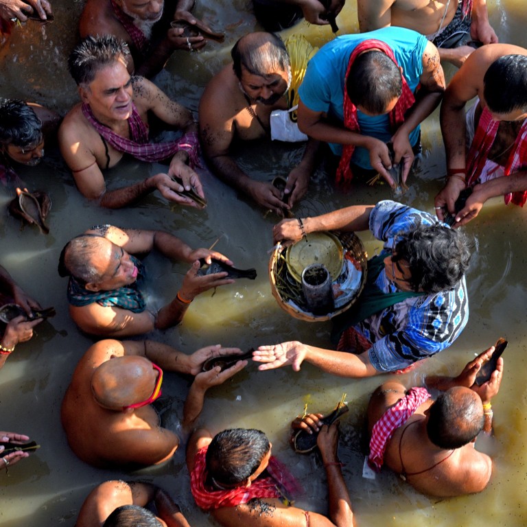 Hindu devotees perform rituals in the Ganges river. India is anticipating a fresh surge in cases with religious festivals this and next month. Photo: DPA