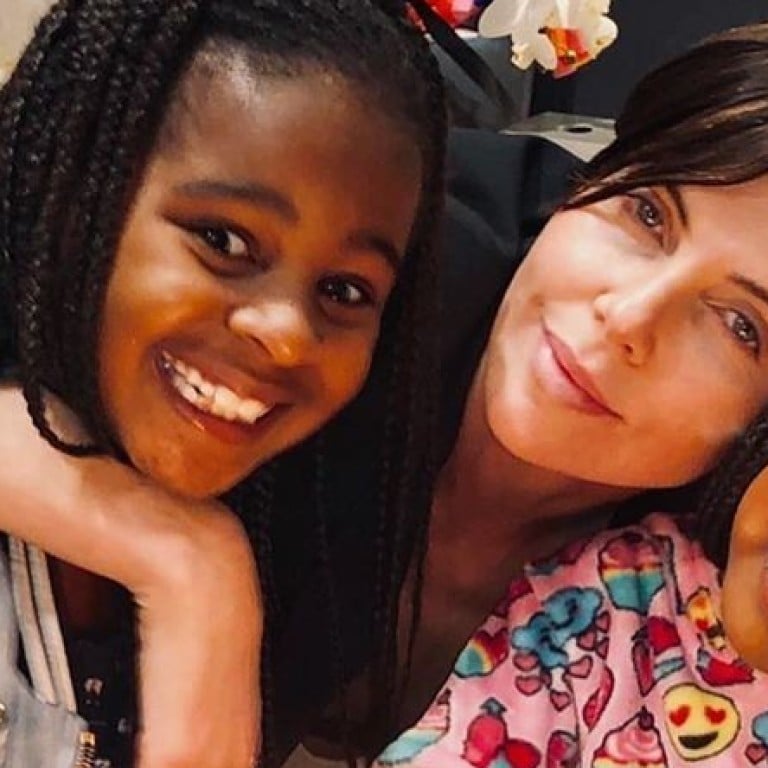 Jackson Theron (left) with mum Charlize Theron and sister August. Photo: @charlizeafrica/Instagram