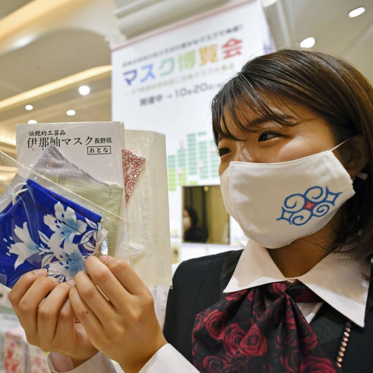 A department store employee wears a face mask in Osaka on October 7. Photo: Kyodo