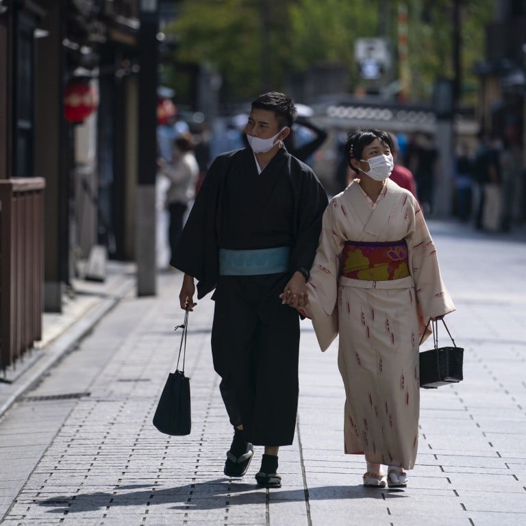 A Japanese couple in Kyoto, until this year, one of Japan’s most popular tourist destinations. Photo: EPA-EFE