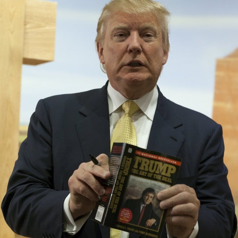Then-presidential candidate Donald Trump holds a copy of his book, The Art of the Deal in June 2015. Publishing industry staff are conflicted over the possibility that he will publish a memoir after leaving The White House. Photo: Reuters