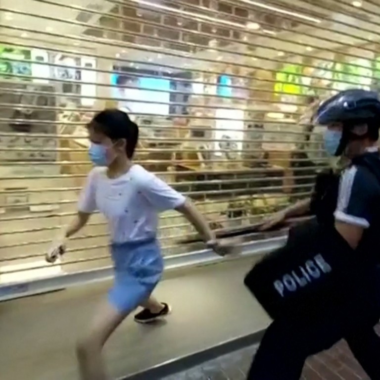 Hong Kong police officer tackles and pins 12-year-old girl to ground during anti-government rally