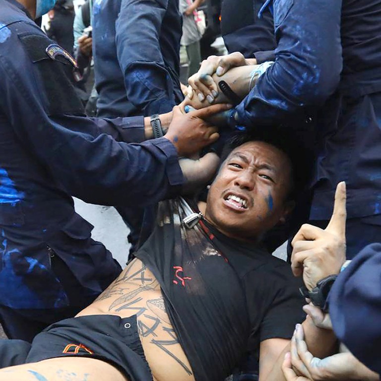 Thai police arrest 21 at pro-democracy rally, drawing chants against royal motorcade