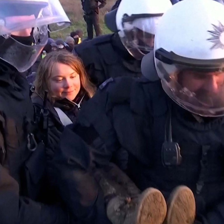 Greta Thunberg all smiles as German police carry her away from protest
