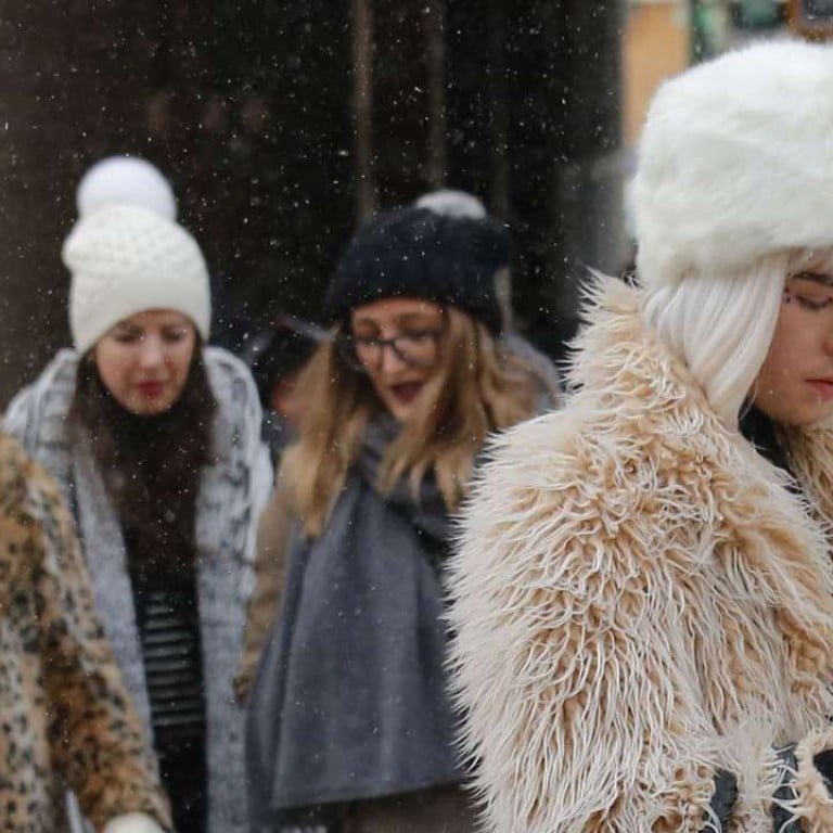 Guests brave a snow storm to view the Tadashi Shoji fashion show at New York Fashion Week. Photo: AP