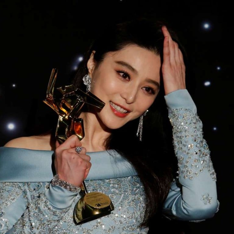 Chinese actress Fan Bingbing celebrates with her best actress award at the Asian Film Awards in Hong Kong. Photo: REUTERS