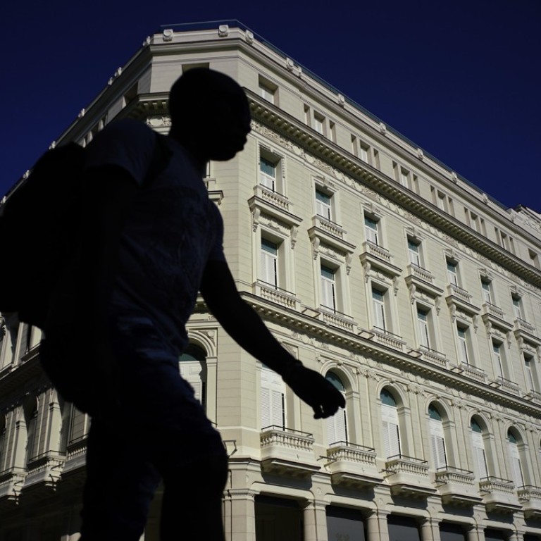 A man walks in front of the Manzana de Gomez Kempinski five-star hotel in Havana. the business arm of the Cuban military has transformed a century-old shopping arcade into the five-story Manzana. Photo: AP