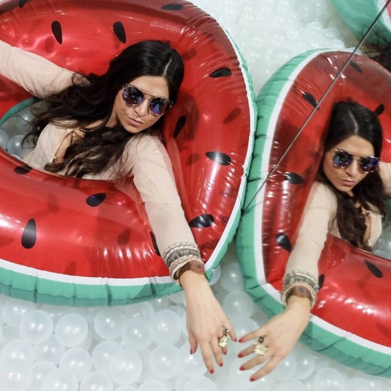 Visitors enjoy the ball pit at "The beach" an interactive art installation that was designed by New York-based collective Snarkitecture and installed to mark the 20th anniversary of the French concept store Colette on March 25, 2017 at the Musee des arts decoratifs in Paris. Photo: AFP