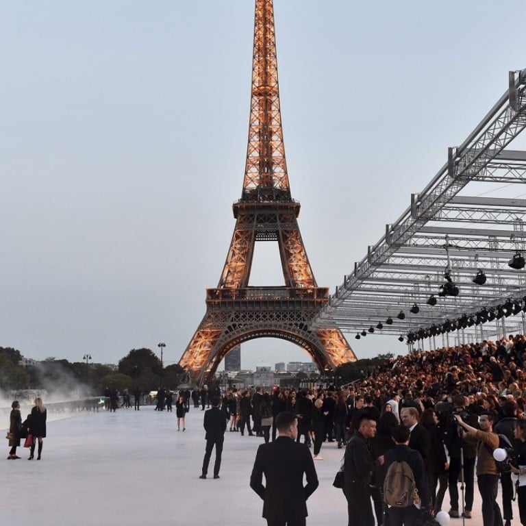 The crowd gathers at the Eiffel Tower in Paris for Yves Saint Laurent’s 2018 spring/summer ready-to-wear collection fashion show. Photo: AFP