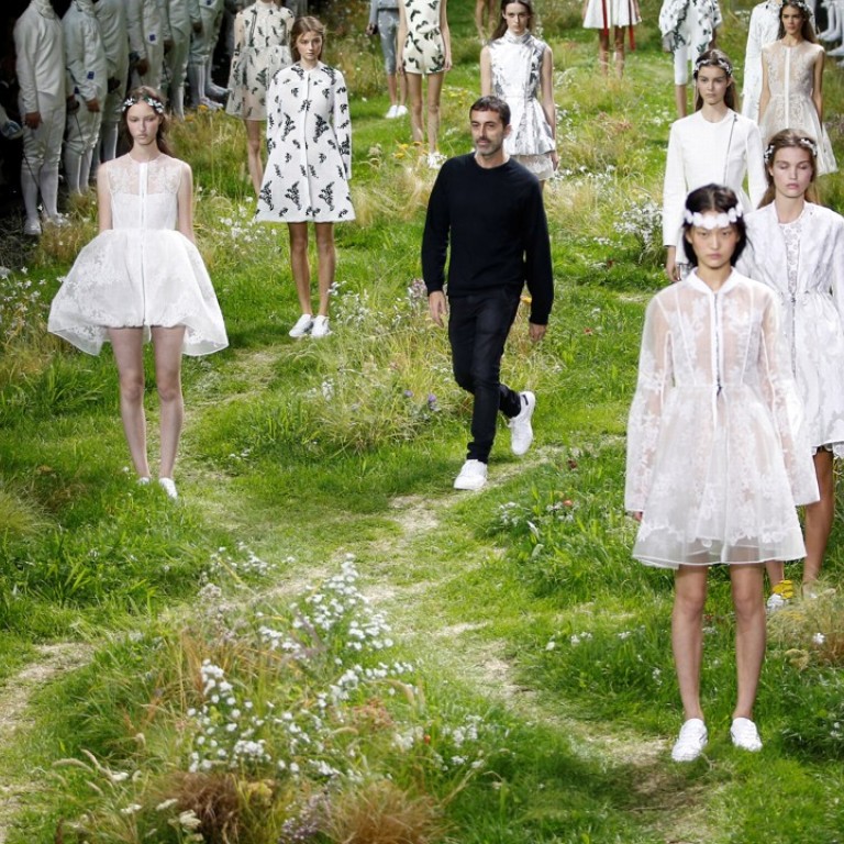 Italian designer Giambattista Valli (centre) appears with models in Paris at his spring/summer 2016 women's ready-to-wear collection for Moncler Gamme Rouge. Photo: Reuters