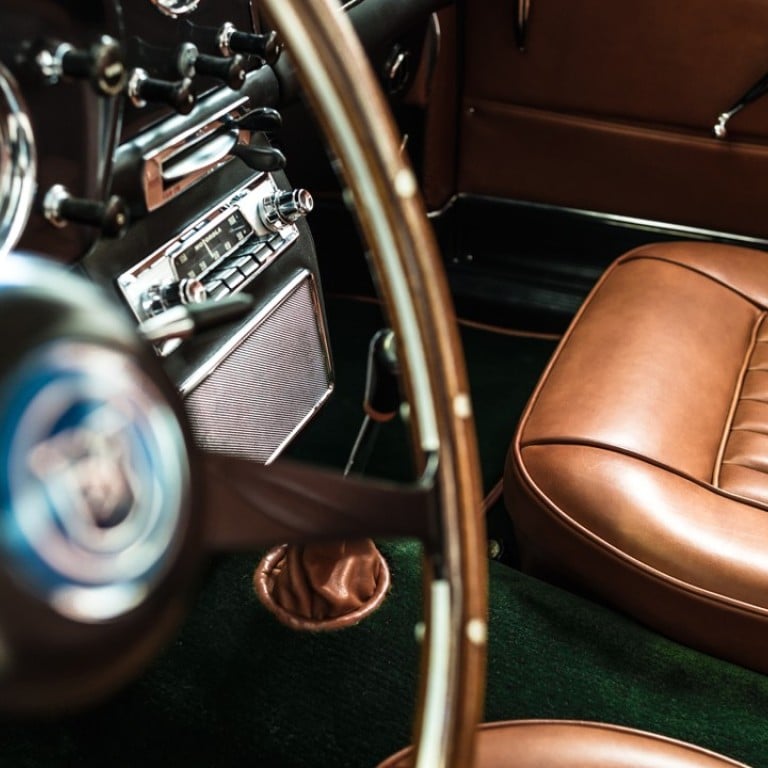 The interior of an Aston Martin DB4 in gold calfskin and rug in English green New Zealand wool, customised by Hermès.