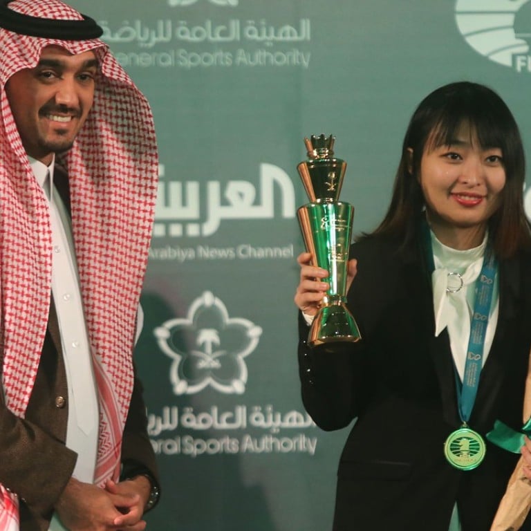 Ju Wenjun receives her trophy for winning the World Rapid Chess Championship in Riyadh, Saudi Arabia, from Saudi Prince Abdulaziz Bin Turki al-Faisal. Photo: Getty Images