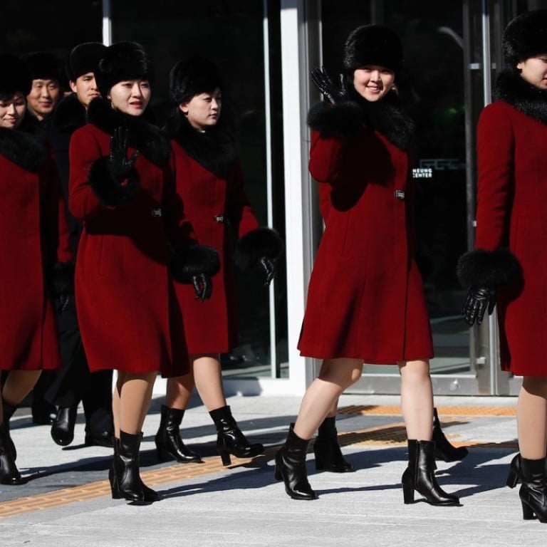 Members of North Korea's Samjiyon Orchestra and art troupe wave as they leave the Gangneung Arts Center on Wednesday, the day before giving their first performance in South Korea since 2002. Photo: AP