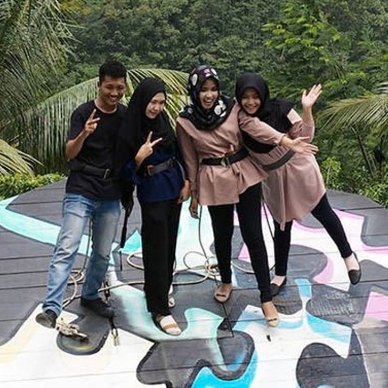 Visitors on a platform pose at the Pulepayung tourist attraction in Kulon Progo regency, Special Region of Yogyakarta, Indonesia. Photo: Dimas Ardian/Bloomberg