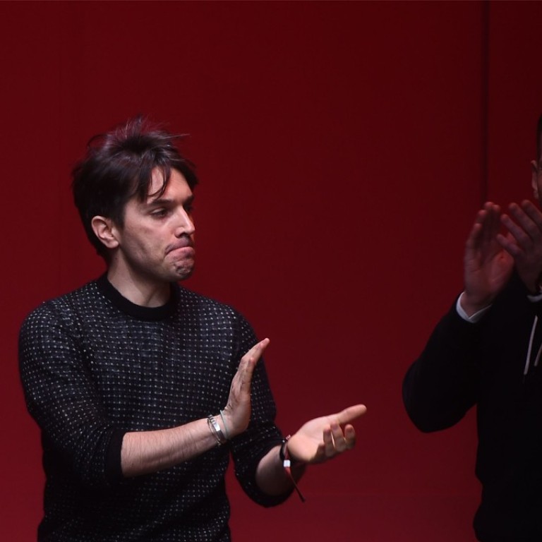 Fashion designers Guillaume Meilland (left) and Paul Andrew, acknowledge the audience at the end of the Salvatore Ferragamo show in Milan. Photo: AFP