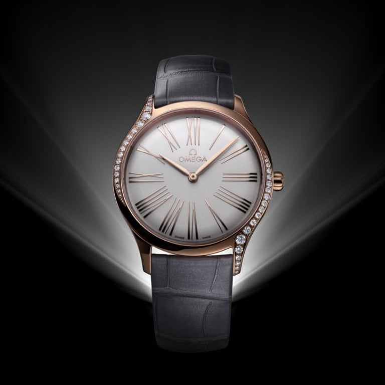 Omega’s De Ville Trésor 36 mm comes in 18ct Sedna gold with a lacquered opaline silver dial and grey leather straps.