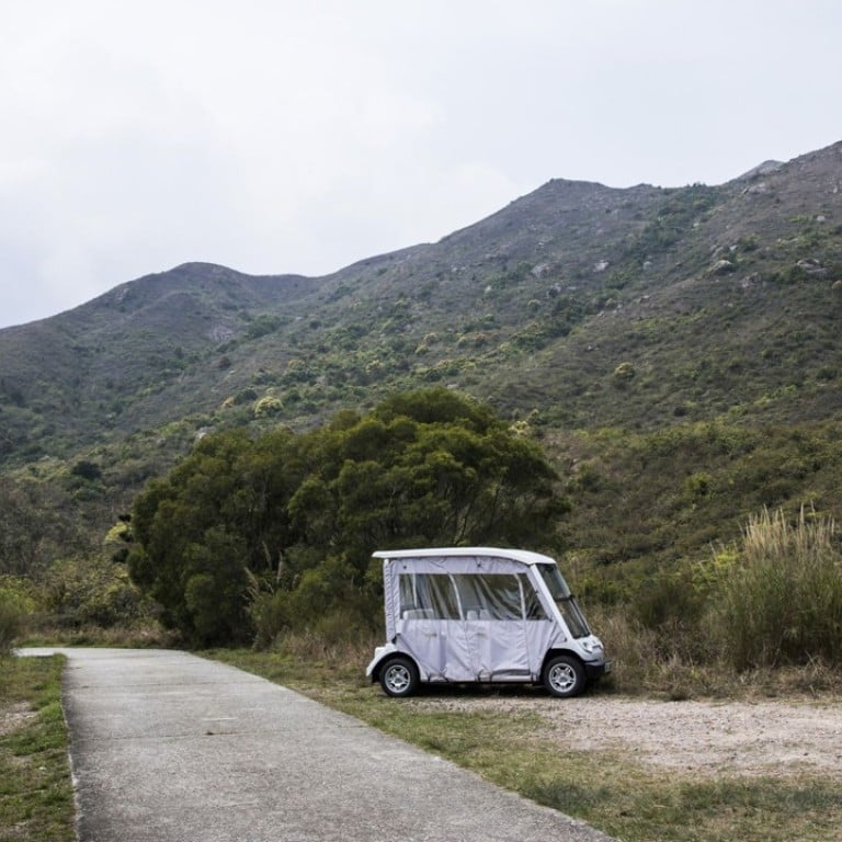 A golf cart sits parked next to a trail on a hilly side at Discovery Bay. Photo: Justin Chin/Bloomberg