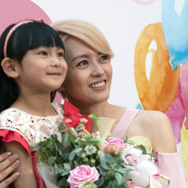 Hong Kong singer and actress Gigi Leung (right) pictured with a child at the Nanos store opening in Harbour City, Tsim Sha Tsui, on Mother's Day.
